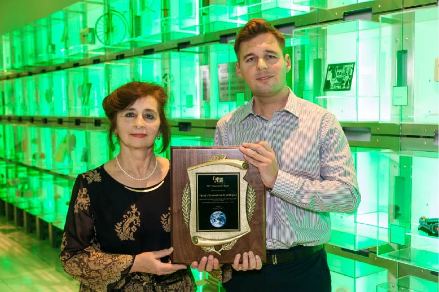 Elena Andriukova (Arkhipov's daughter) and Sergei (his grandson) holding the Future of Life Award plaque at the 2017 ceremony in London