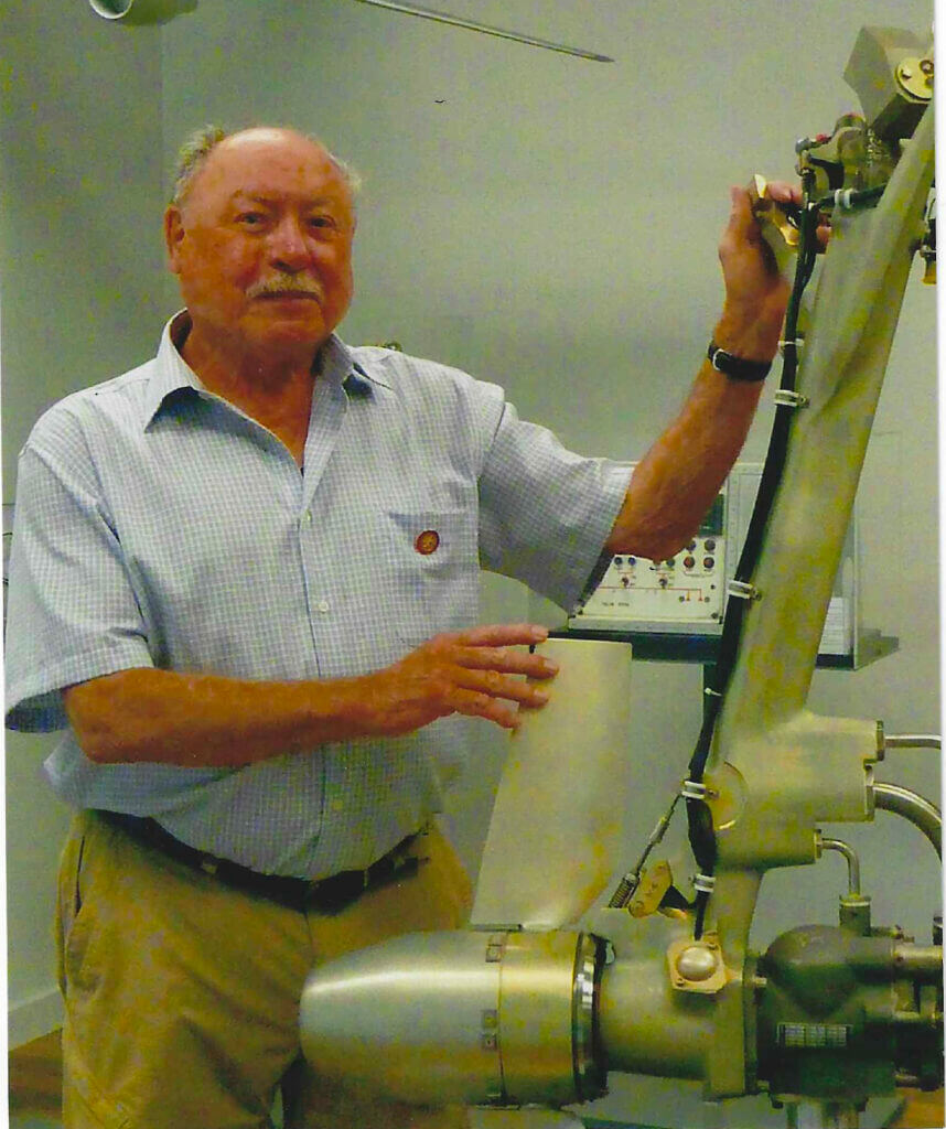 Captain Pearson with a Ram Air Turbine display at the Gimli Glider Exhibit, 2023