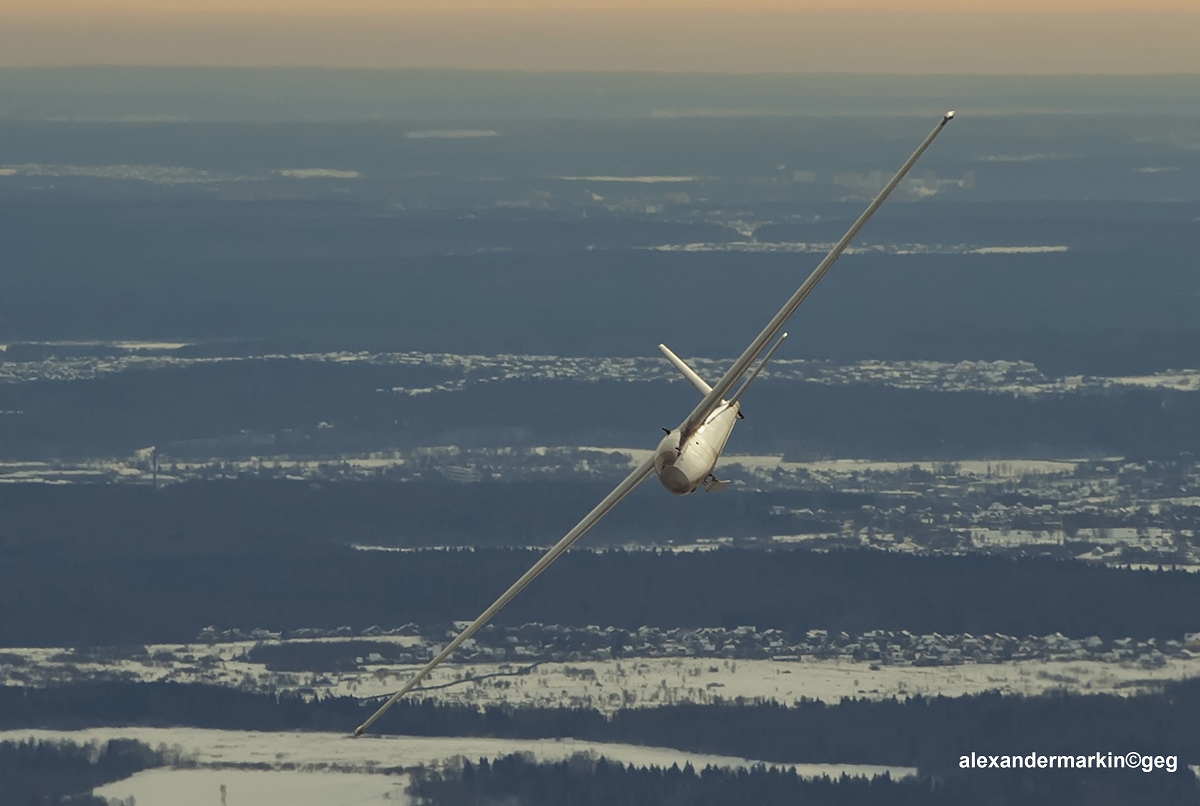 A Blanik L-13 sailplane in flight, banking over a winter landscape — the same type of glider Captain Pearson flew on weekends